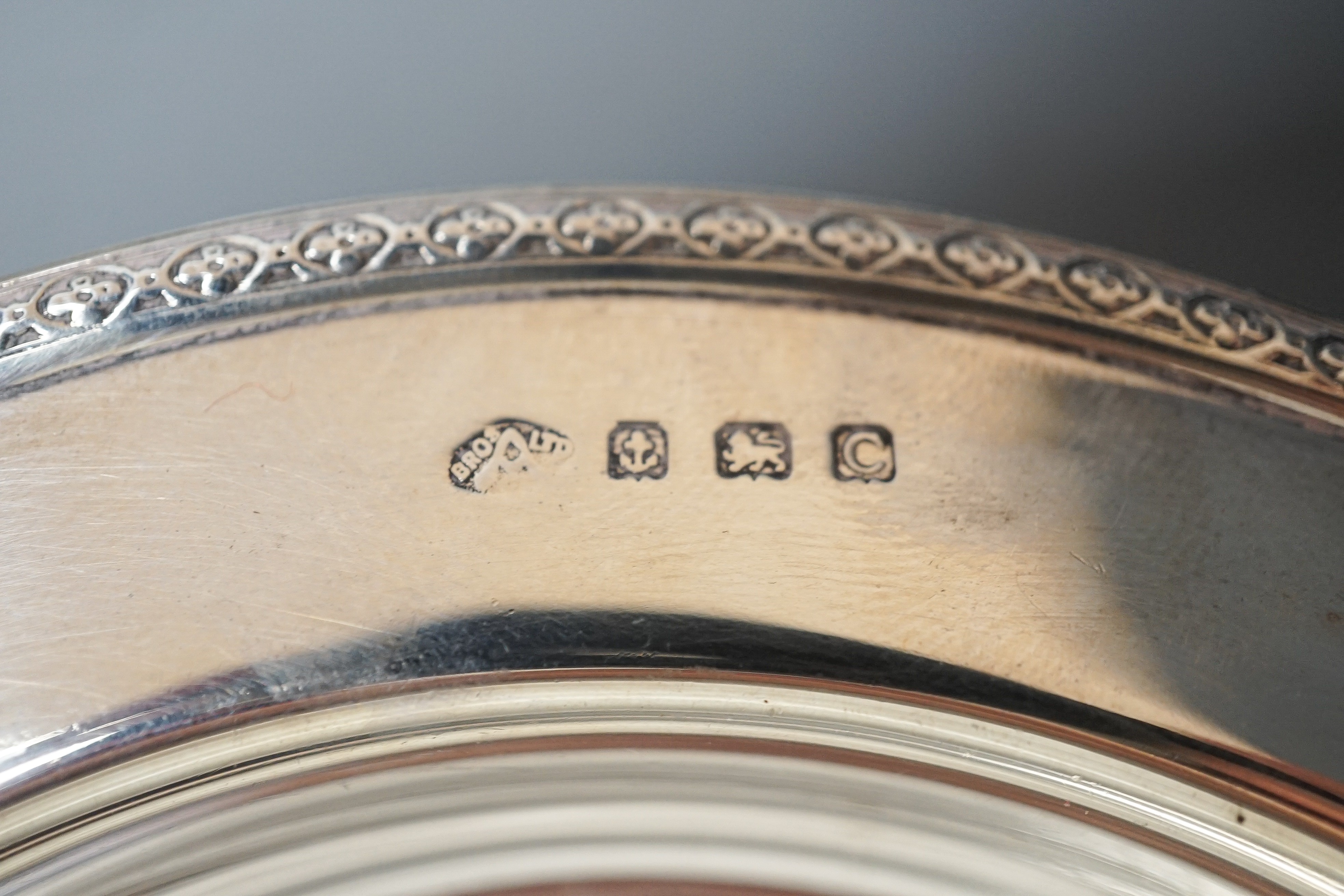 A George V silver shallow dish or stand, Adie Bros. Birmingham, 1927, 16.2cm and a silver ashtray, 11oz.